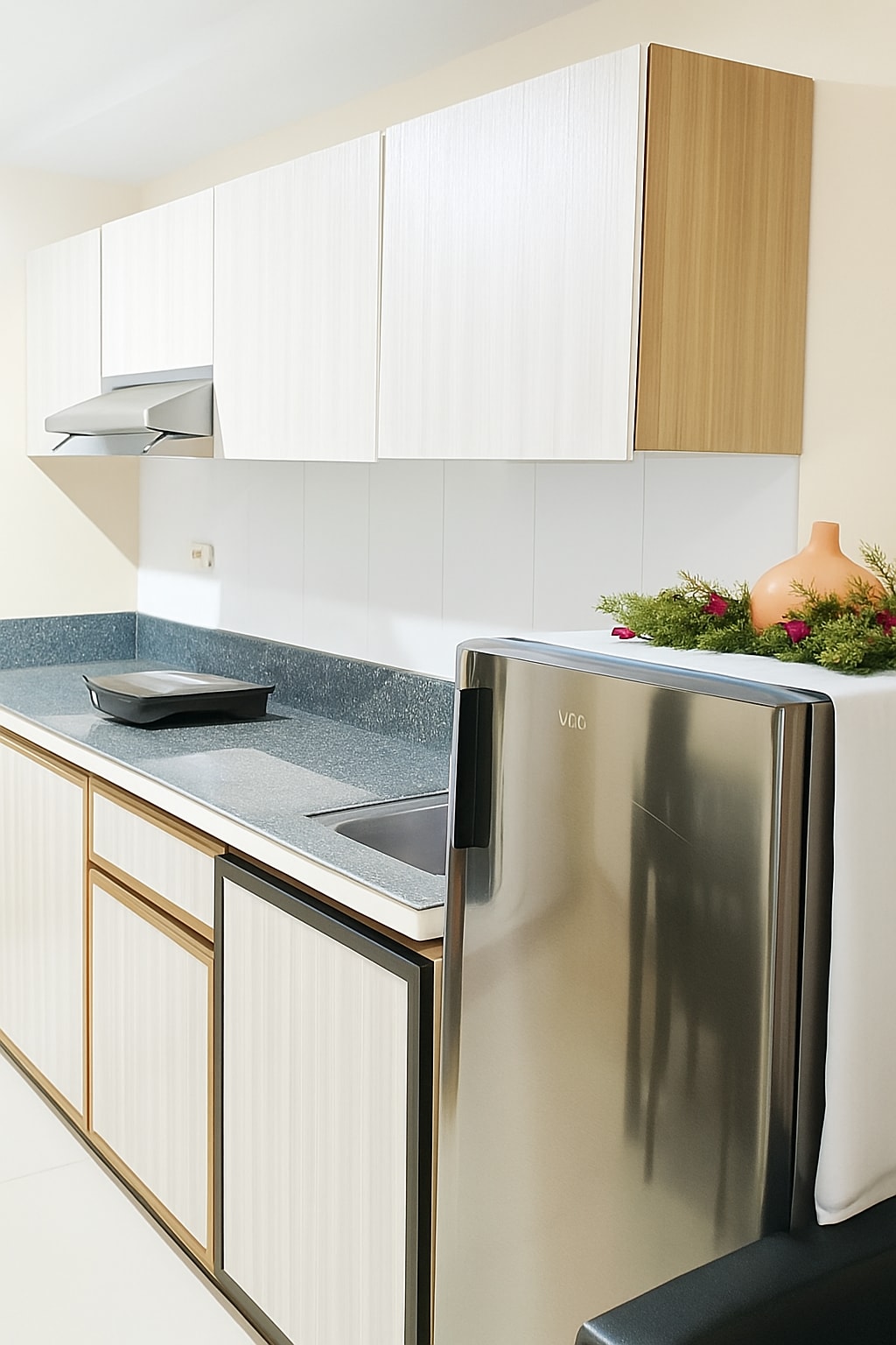 White kitchen units with a stainless fridge